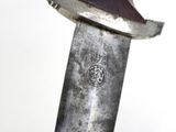a close up of a knife on a white surface