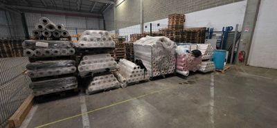 a large amount of boxes and pallets in a warehouse