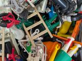 a pile of assorted toys in a bin with a ladder