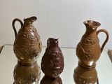 three vases sitting on top of a glass table