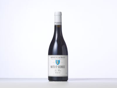 a bottle of red wine sitting on top of a table