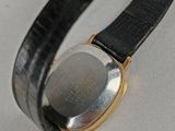 a close up of a wrist watch with a black leather band