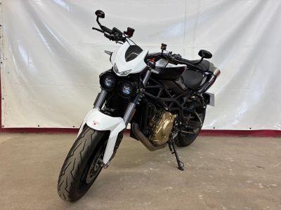 a black and white motorcycle parked in a garage