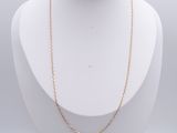 a close up of a necklace on a mannequin with a white background