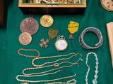 a table with many different items on it including a clock and other items