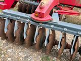 an image of a tractor with a plow attached to it ' s back