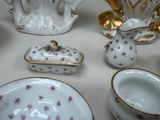 many different types of porcelain dishes and bowls on the table