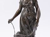 bronze statue of a woman with a dog on a marble base