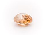 a close up of a yellow and white diamond on a white surface