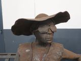 a statue of a man wearing a hat and glasses