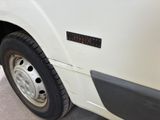 a close up of a white truck with a black stripe