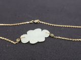 a gold chain bracelet with a white flower on it