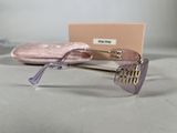 purple sunglasses with gold details and a pink case on a table