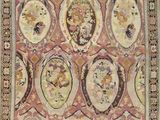 an antique rug with many faces on a pink background