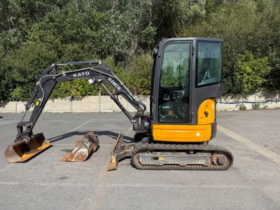 a small excavator that is parked in a parking lot