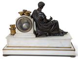 a statue of a woman sitting on top of a clock