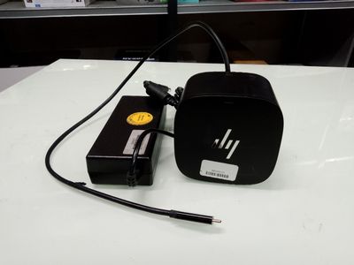 a black hp power adapter sitting on a white table