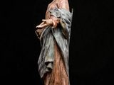 a statue of a woman holding a book in her hands