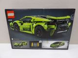 the box is open to show the model of a green sports car