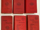 six red books sitting on top of a white table next to each other