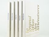 three books are stacked on top of each other on a white surface