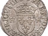 an old silver coin with a crown on top of it