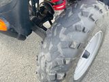 a close up of a red atv with a big tire