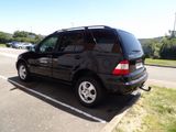 a picture of a black suv parked in a parking lot