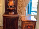 a cabinet and a table in the corner of a room