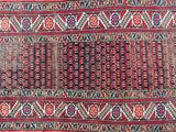 an image of a red and blue rug with a pattern on it