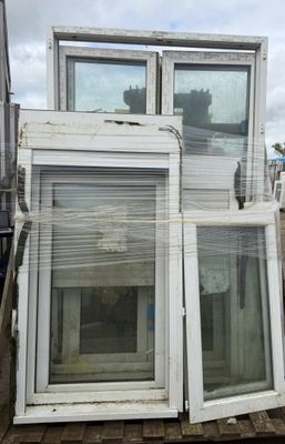 a pile of windows sitting on top of a pallet