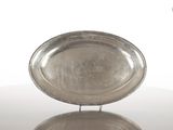 un plateau en argent posé sur une table en verre