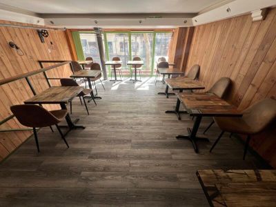 tables and chairs are lined up in a room with wood paneled walls