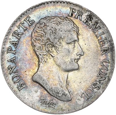 Gros plan sur une pièce de monnaie portant le visage d'un homme