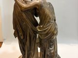 a statue of two women that are standing next to each other