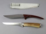 three different types of knives sitting on a table