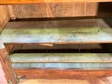 an old wooden cabinet with two shelves on it