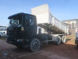 a black dump truck that is parked in a lot