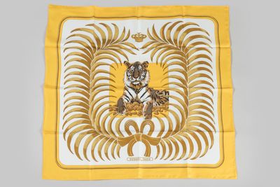a close up of a yellow and white scarf with a tiger on it