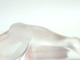 a glass sculpture of a horse on a white surface