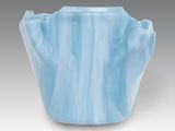 blue vase with a wavy design on the outside of it