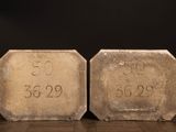 two cement blocks with numbers on them sitting on a table