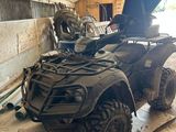 an image of a dirty four wheeler in a garage