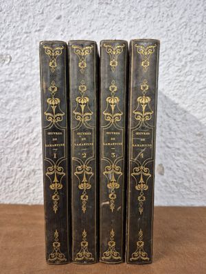 a set of three books sitting on top of a wooden table