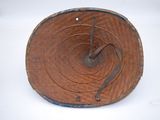 a wooden plate with a clock on it on a white surface