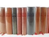 books lined up in a row on a white surface