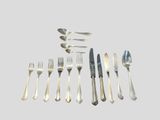 a lot of silverware on a table with spoons and forks