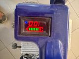 a blue machine that has a red display on it