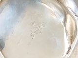 a close up of a silver plate on a table
