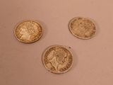 three different types of coins are shown on a white surface